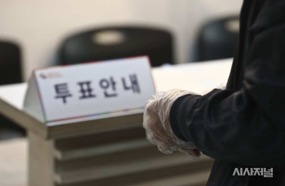 제21대 국회의원 선거일인 15일 오전 서울 종로구 혜화동 제3투표소를 찾은 시민이 투표 전 일회용 장갑을 착용하고 있다. ⓒ고성준 기자